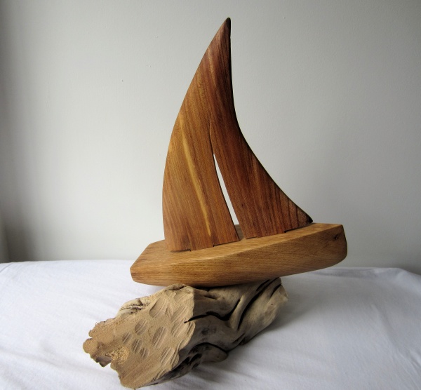 Hand carved wooden ornamental sailing boat in elm and oak